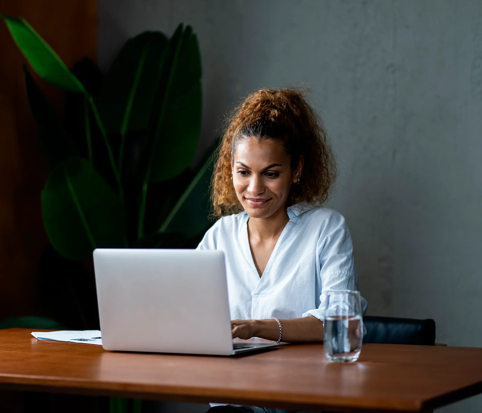 A customer managing her accounts on a laptop